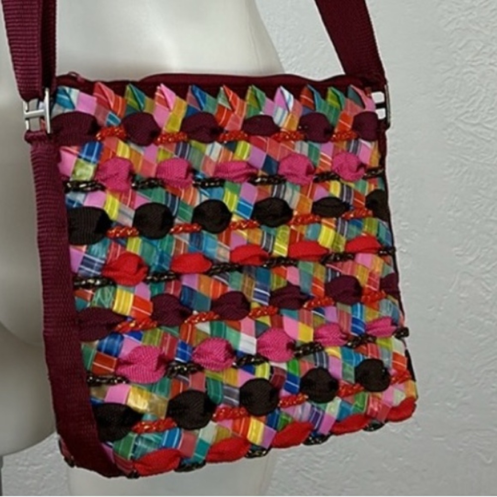 Hand woven colorful plastic washable purse with canvas straps. Reduce waste